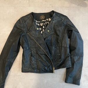 Black leather jacket with gold zippers